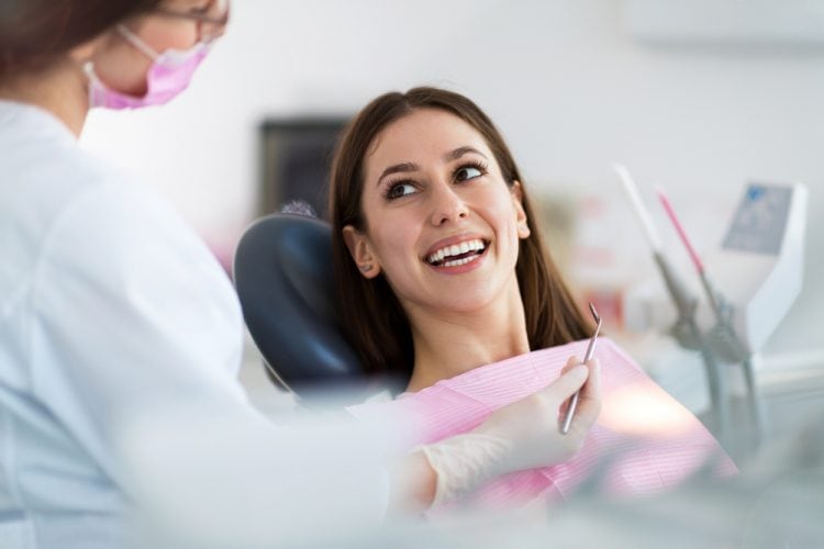 Happy women looking at dentist smiling